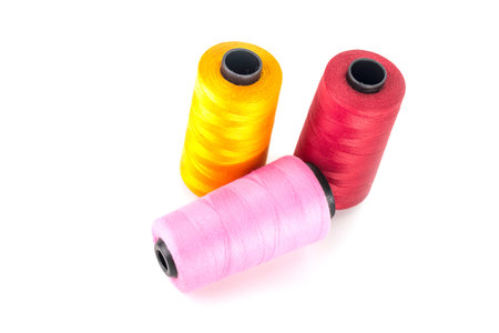 Three bobbin thread isolated on white