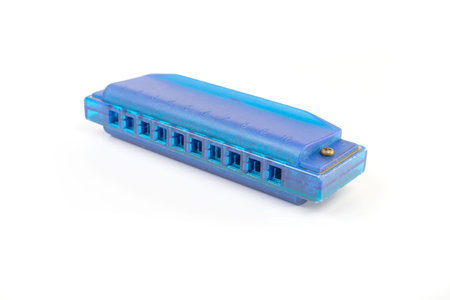 One blue harmonica on a white background