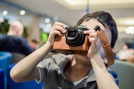 young child holding a instant cameraの写真素材