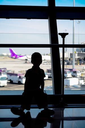 Boy looking at planes in the airportのeditorial素材