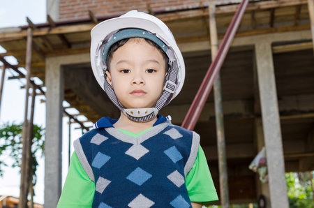 Boy pretending to be a construction workerの写真素材