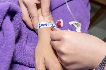 Close up of patient in hospital with saline intravenousの写真素材