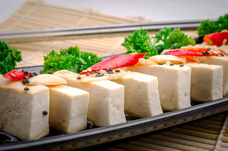 Silken tofu with gochujang and sesame oil decorate with spring onion and gingerの写真素材