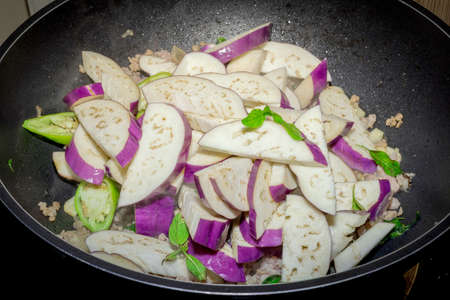Fried eggplant with garlic sauce in Black pan.の写真素材