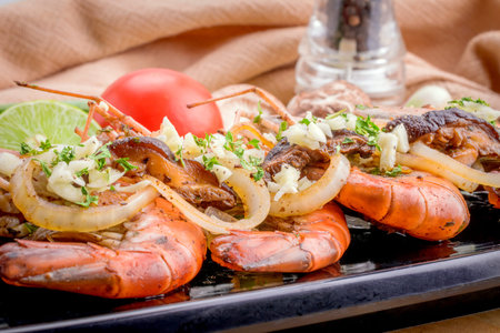 Baked shrimp in a bowl on board.の写真素材