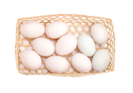 White eggs in basket isolated on white backgroundの写真素材