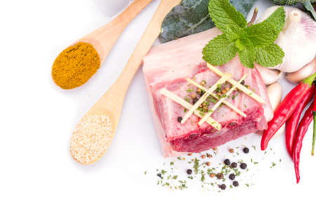 Pork belly with herbs spices on a white backgroundの写真素材