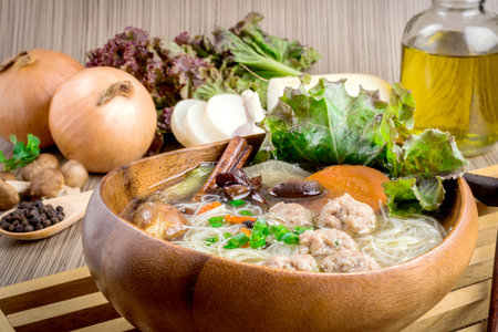 Thai ramen noodle on table with garnish and vegetables.の写真素材