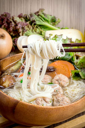 Thai ramen noodle on table with garnish and vegetables.の写真素材