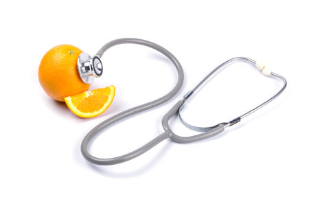 Orange with stethoscope on white background