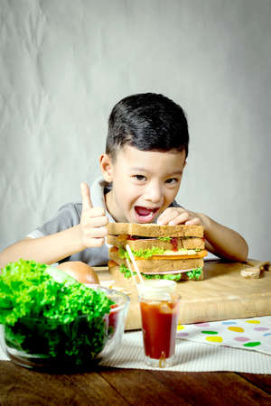 Little Boy Making a Sandwich In Kitchenの写真素材