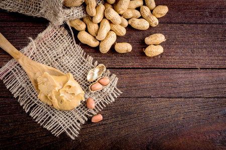 peanut butter and peanuts on the wooden floorの写真素材