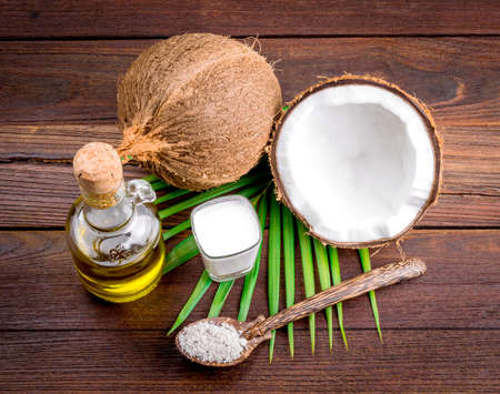 Coconut milk and coconut oil on wooden tableの写真素材