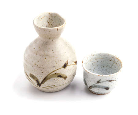 Japanese sake cup and bottle on white backgroundの写真素材