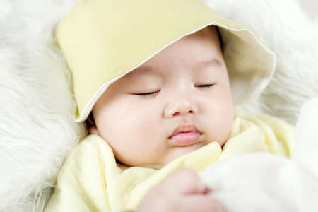Asian baby boy lying on bedの写真素材