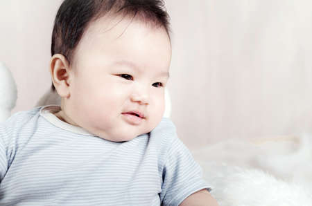 Asian baby boy lying on bedの写真素材