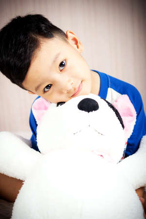 The boy is happy with doll dog lovely friend on the bed, Family Lovely Conceptの写真素材