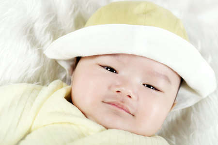 Asian baby boy lying on bedの写真素材