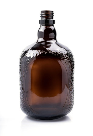 Brown transparent glass bottle, isolated on white.の写真素材