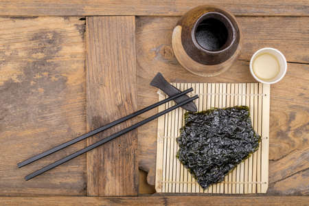 Nori sheets with sticks on the wood backgroundの写真素材