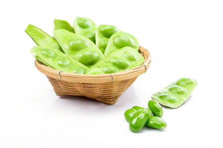 Tropical stinking edible beans in basket on white background. (Parkia Speciosa)