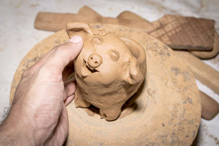 manufacture of ceramic vessel hands of the child and adult, Household pottery rural north of Thailand.の写真素材