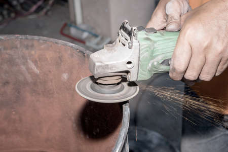 Workers operate the grinder without protection.の写真素材