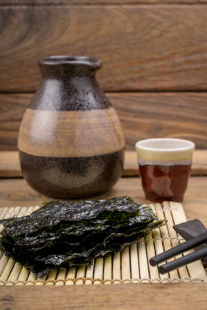 Nori sheets with sticks on the wood backgroundの写真素材