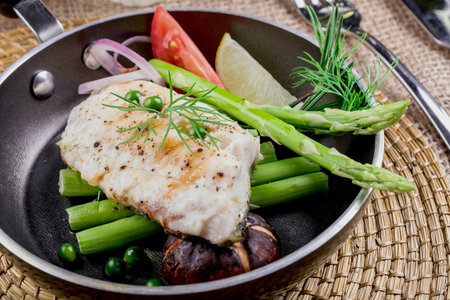 Grilled salmon and vegetables on dining table.の写真素材