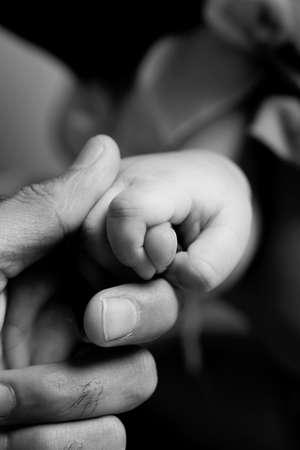 concept of love and family. hands of father and baby closeupの写真素材