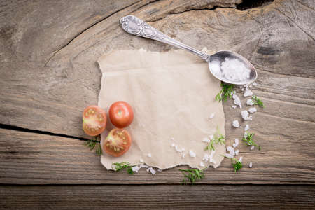 Tomatoes and salt on wood table.の写真素材