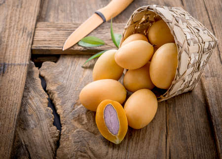 sweet marian plum thai fruit on woodeb table.の写真素材