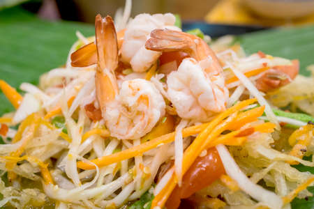 papaya salad, spicy green papaya salad with fresh shrimp.の写真素材