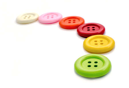 Various colorful sewing buttons on white backgroundの写真素材