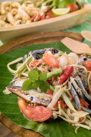 papaya salad with crab on wood tableの写真素材