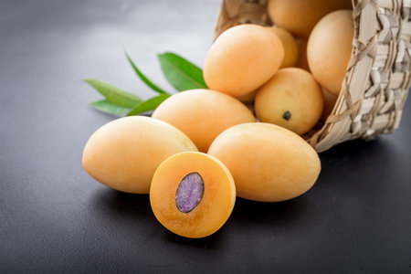 sweet marian plum thai fruit on black background