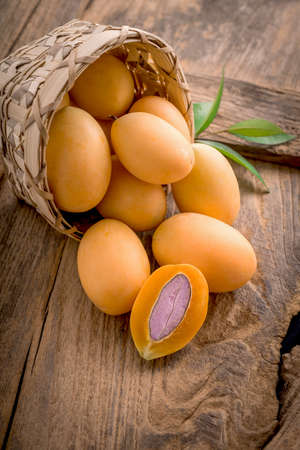 sweet marian plum thai fruit on woodeb table.の写真素材