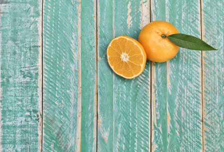fresh orange fruit placed on wooden floor