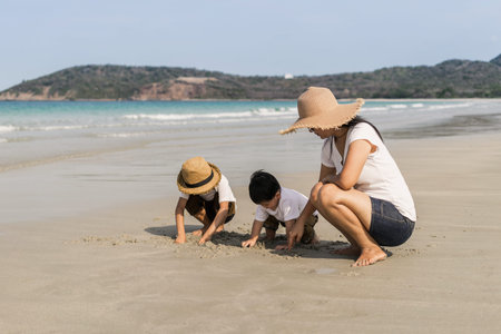 Young mother with her two kids on tropical beach vacation