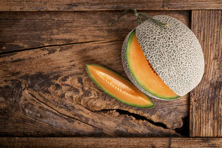 Melon on wooden tableの写真素材