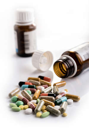 Medicines, supplements and drugs in a bottle on a white backgroundの写真素材