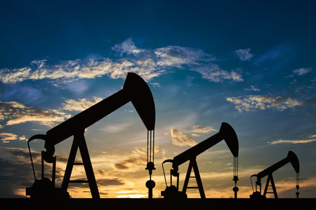 Oil pump oil rig energy industrial machine for petroleum in the sunset background for design