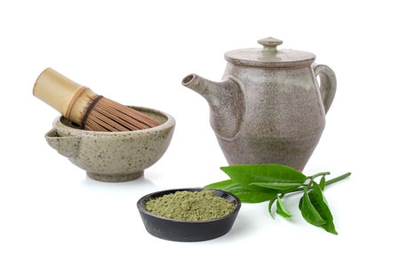 Matcha green tea in a bowl and bamboo whisk isolated Matcha is a powder of green tea leaves packed with antioxidants on white background.の写真素材