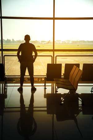 Man in airport. Airplane, view from airport terminal.selective focus,travel concept.の写真素材