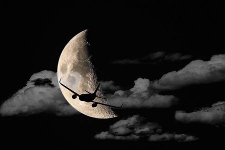 an airplane flying across a full moon, Silhouettes of Aircraft and super moon.