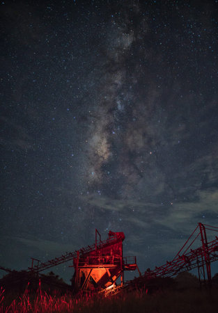 Crushing machine construction industry with the milky way background, Thailand.