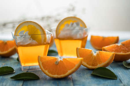 Orange jam in glass jar, selective focus, Fruit jelly with fresh oranges.の写真素材