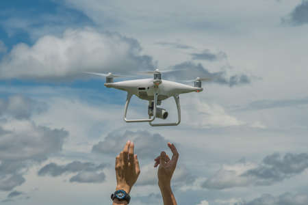 The drone and photographer man hands , The drone with the professional camera takes pictures.の写真素材