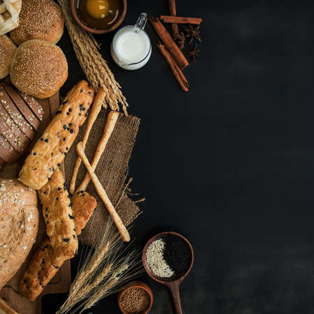 Group of different types of bread on black background, Leave space for text input.の写真素材