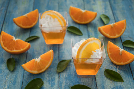 Orange jam in glass jar, selective focus, Fruit jelly with fresh oranges.の写真素材